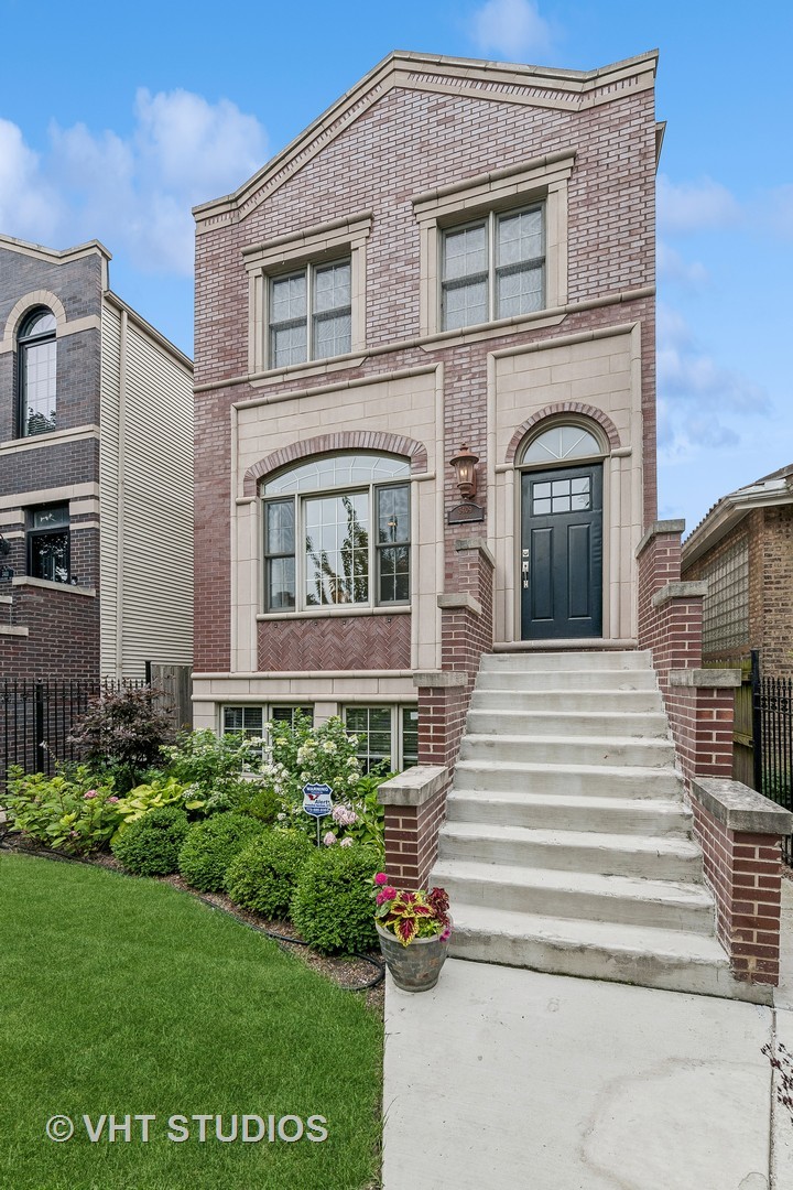 3409 North Ridgeway Avenue Chicago, IL 60618 - Photo 2 of 37 a front view of a house with a garden