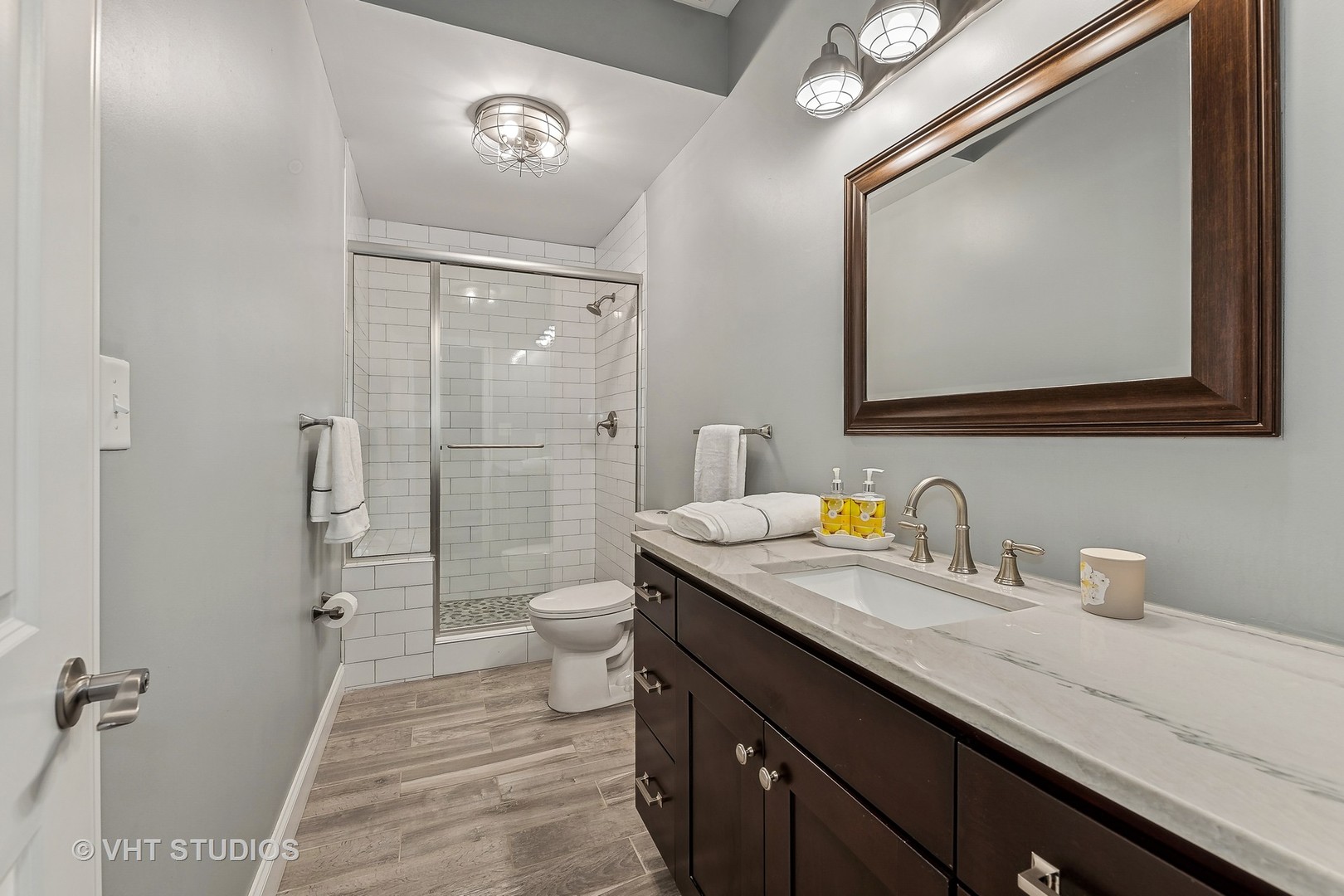 3409 North Ridgeway Avenue Chicago, IL 60618 - Photo 29 of 37 a bathroom with a granite countertop sink mirror and a toilet