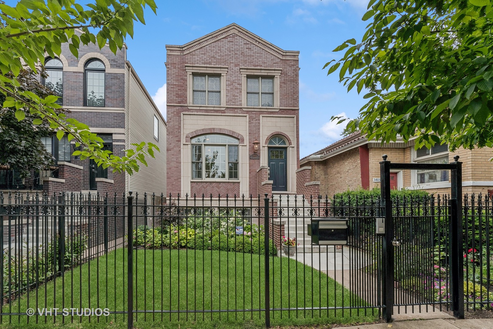 3409 North Ridgeway Avenue Chicago, IL 60618 - Photo 3 of 37 a front view of a house with a garden