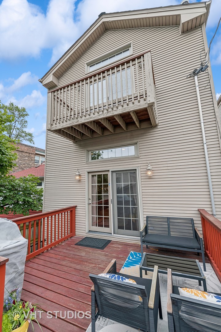 3409 North Ridgeway Avenue Chicago, IL 60618 - Photo 33 of 37 a view of a wooden deck with wooden floor and outdoor seating