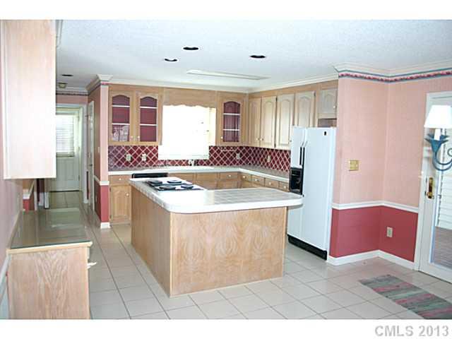 3458 Flat Creek Road Lancaster, SC 29720 - Photo 6 of 8 a living room with stainless steel appliances kitchen island granite countertop a sink and a refrigerator