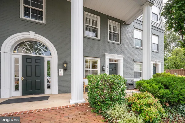 front view of a brick building next to a yard