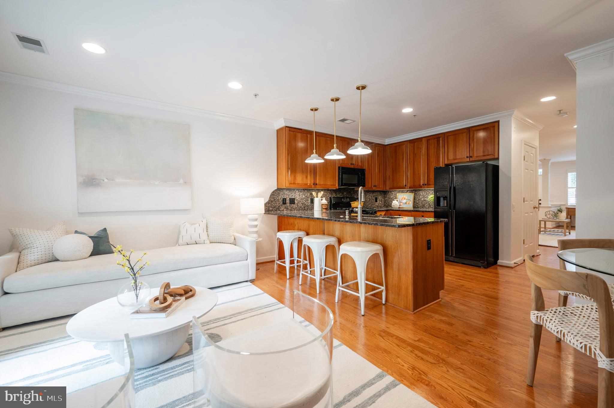 1422 Roundhouse Lane, Unit 1422 Alexandria, VA 22314 - Photo 11 of 73 a kitchen with stainless steel appliances kitchen island granite countertop a refrigerator a stove a sink dishwasher and white cabinets with wooden floor