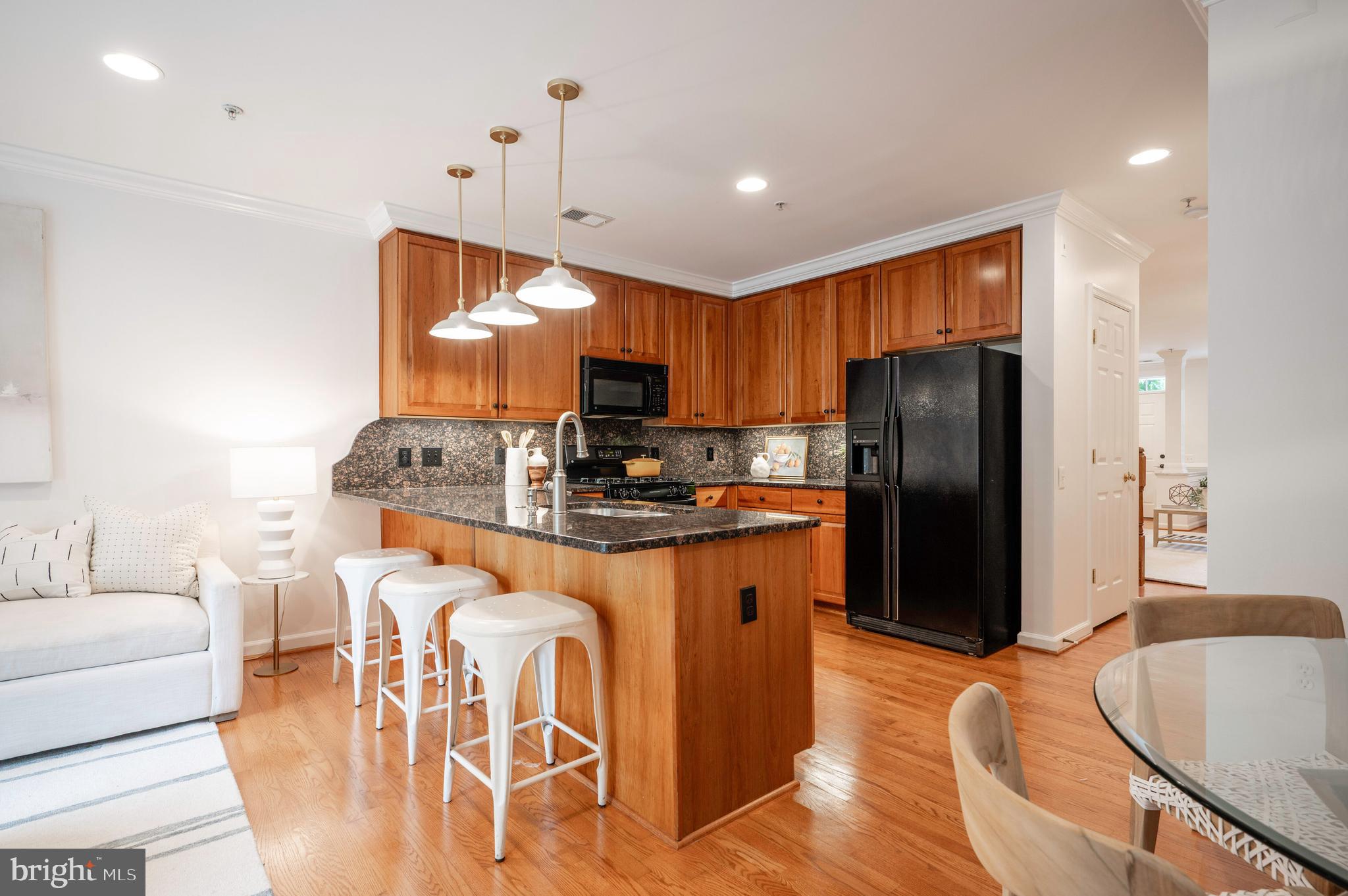 1422 Roundhouse Lane, Unit 1422 Alexandria, VA 22314 - Photo 12 of 73 a kitchen with stainless steel appliances granite countertop a refrigerator a stove a sink dishwasher a dining table and chairs with wooden floor