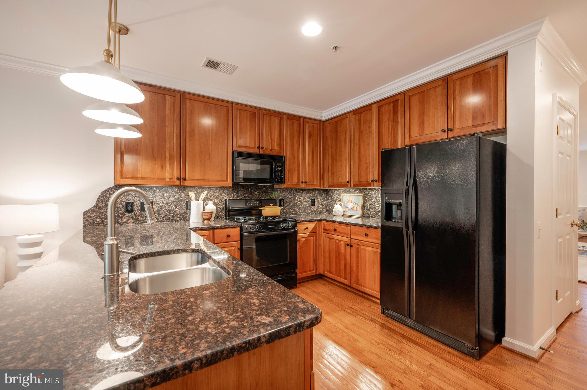 1422 Roundhouse Lane, Unit 1422 Alexandria, VA 22314 - Photo 14 of 73 a kitchen with stainless steel appliances granite countertop a refrigerator a stove top oven a sink and dishwasher