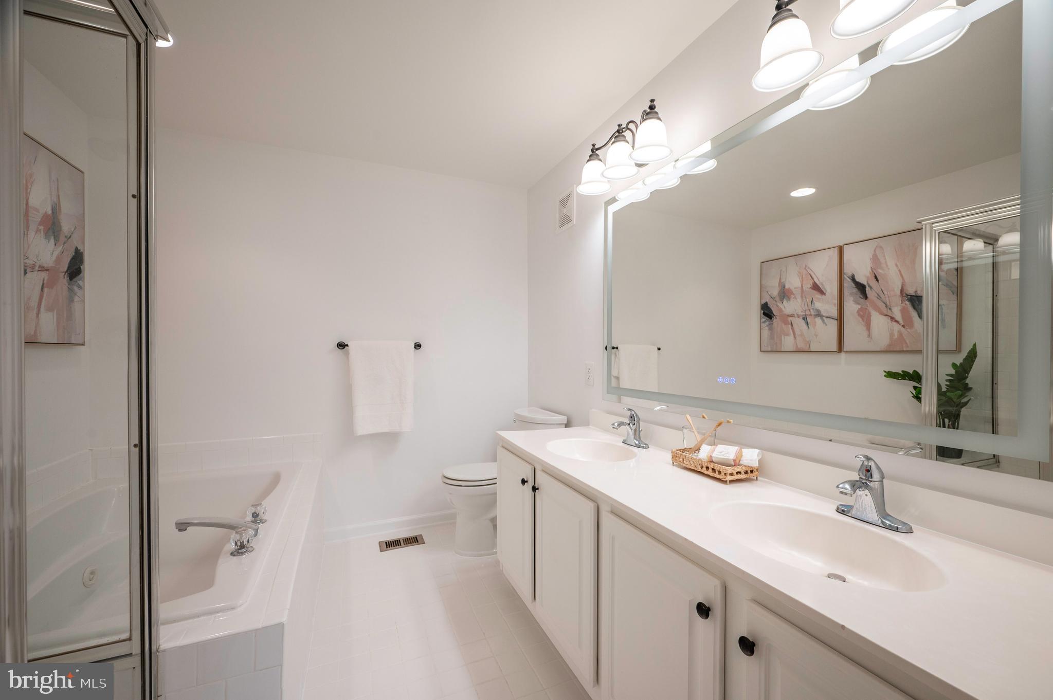 1422 Roundhouse Lane, Unit 1422 Alexandria, VA 22314 - Photo 30 of 73 a spacious bathroom with a double vanity sink mirror and double