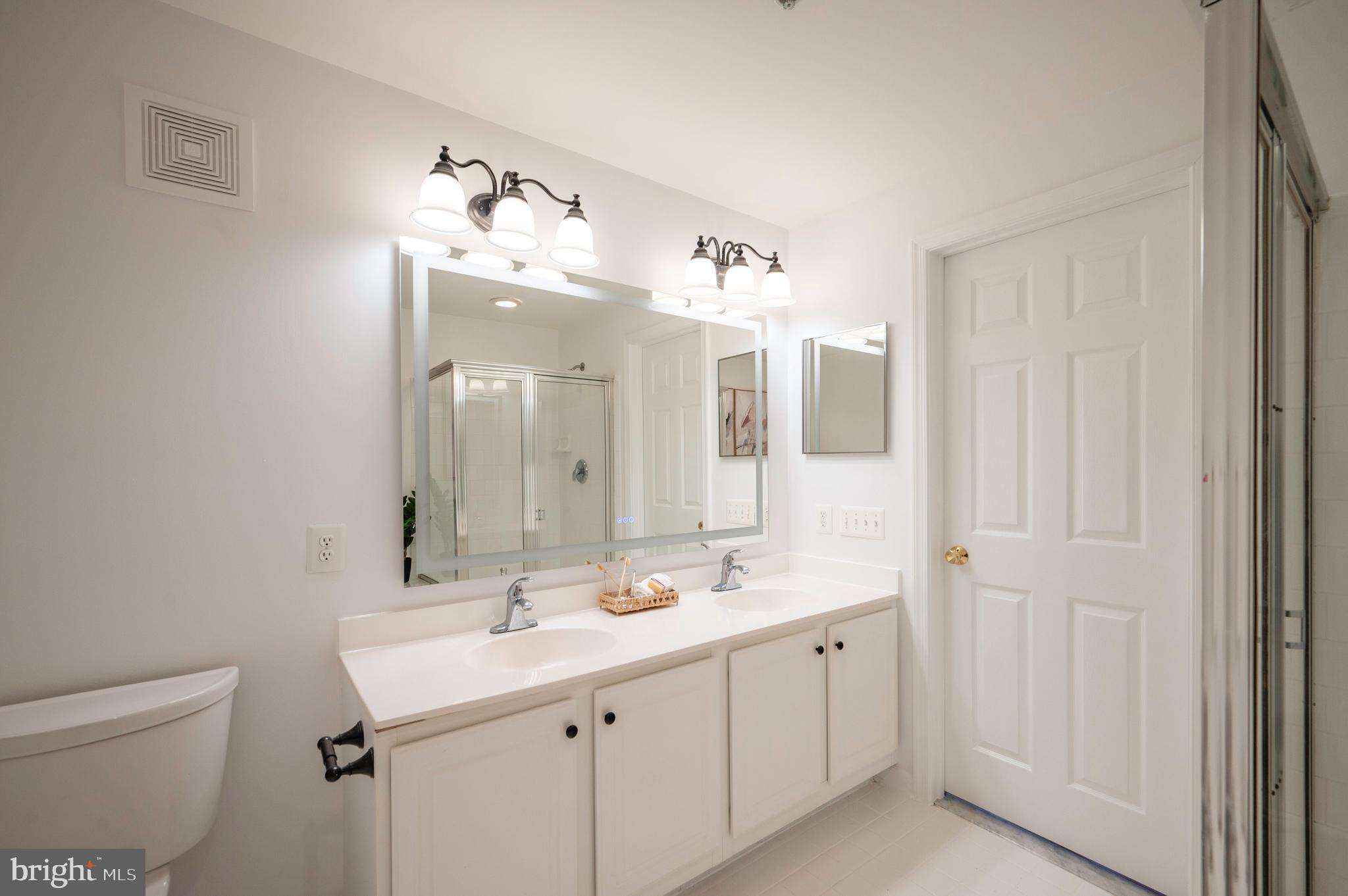 1422 Roundhouse Lane, Unit 1422 Alexandria, VA 22314 - Photo 32 of 73 a bathroom with a double vanity sink mirror and