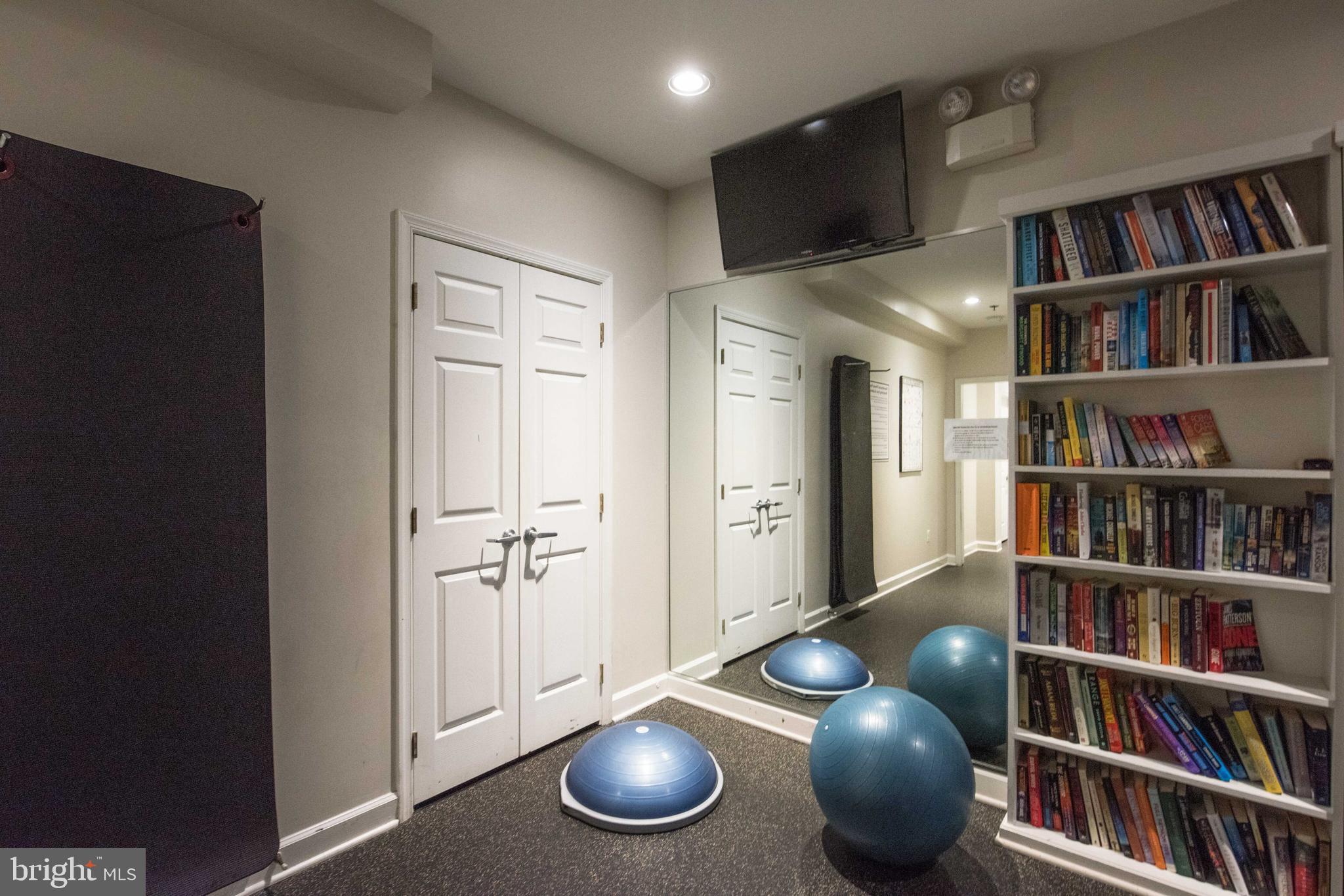 1422 Roundhouse Lane, Unit 1422 Alexandria, VA 22314 - Photo 45 of 73 a living room with lots of furniture and a book shelf
