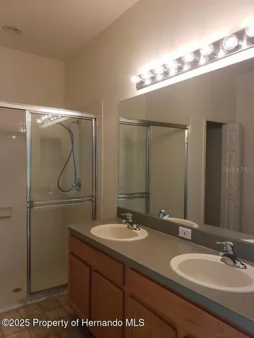 a bathroom with a sink vanity granite and a mirror