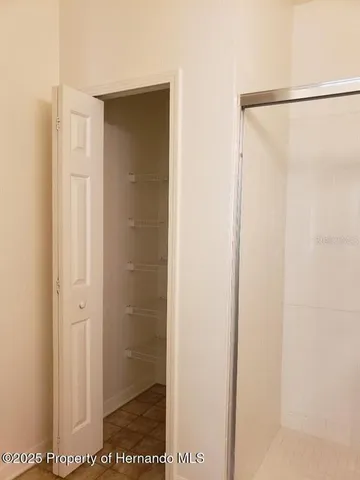 a bathroom with a glass shower door
