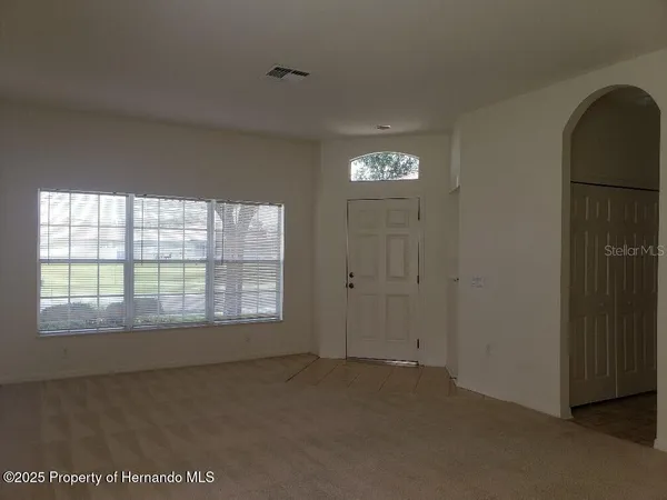 a view of an empty room with a window