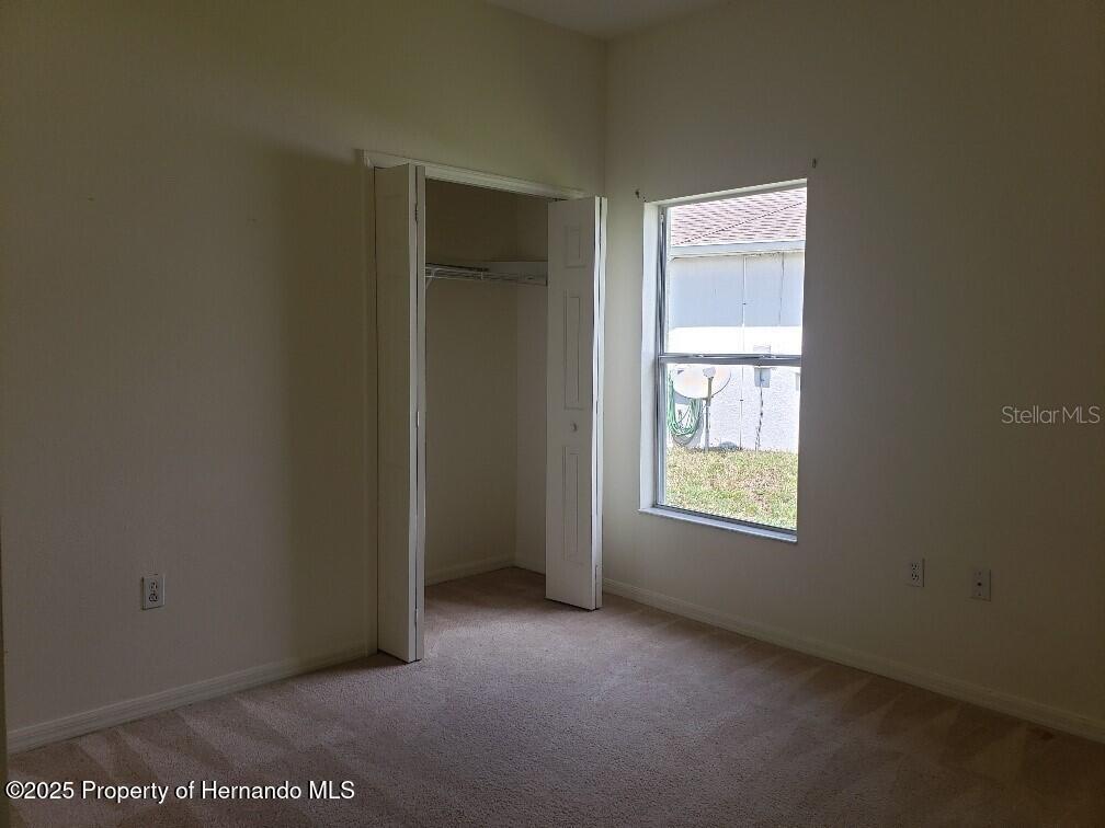 15206 Copper Loop Brooksville, FL 34604 - Photo 23 of 29 a view of an empty room with a window
