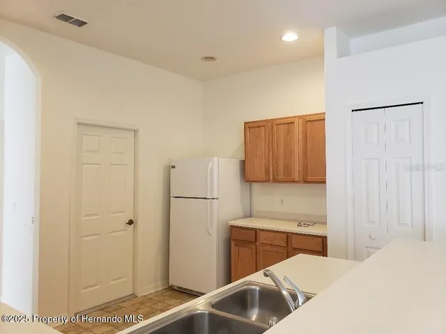 a kitchen with a refrigerator and a sink