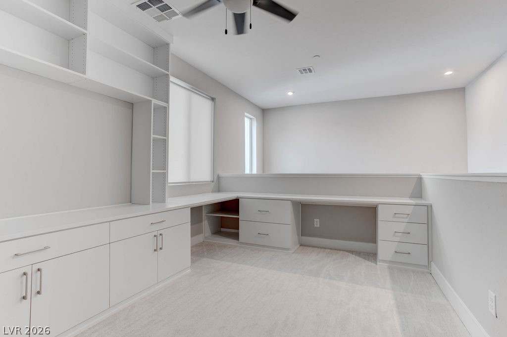 646 Infinity Rdg Street Las Vegas, NV 89138 - Photo 14 of 40 Upstairs loft can be used as an office or study with the built-in desk and shelves.