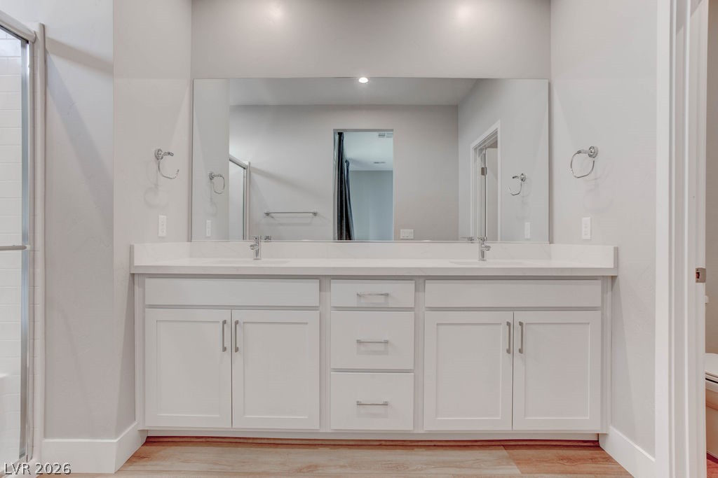 646 Infinity Rdg Street Las Vegas, NV 89138 - Photo 19 of 40 Luxurious primary bath #1 with double vanities, lots of storage space and a spacious walk-in shower.