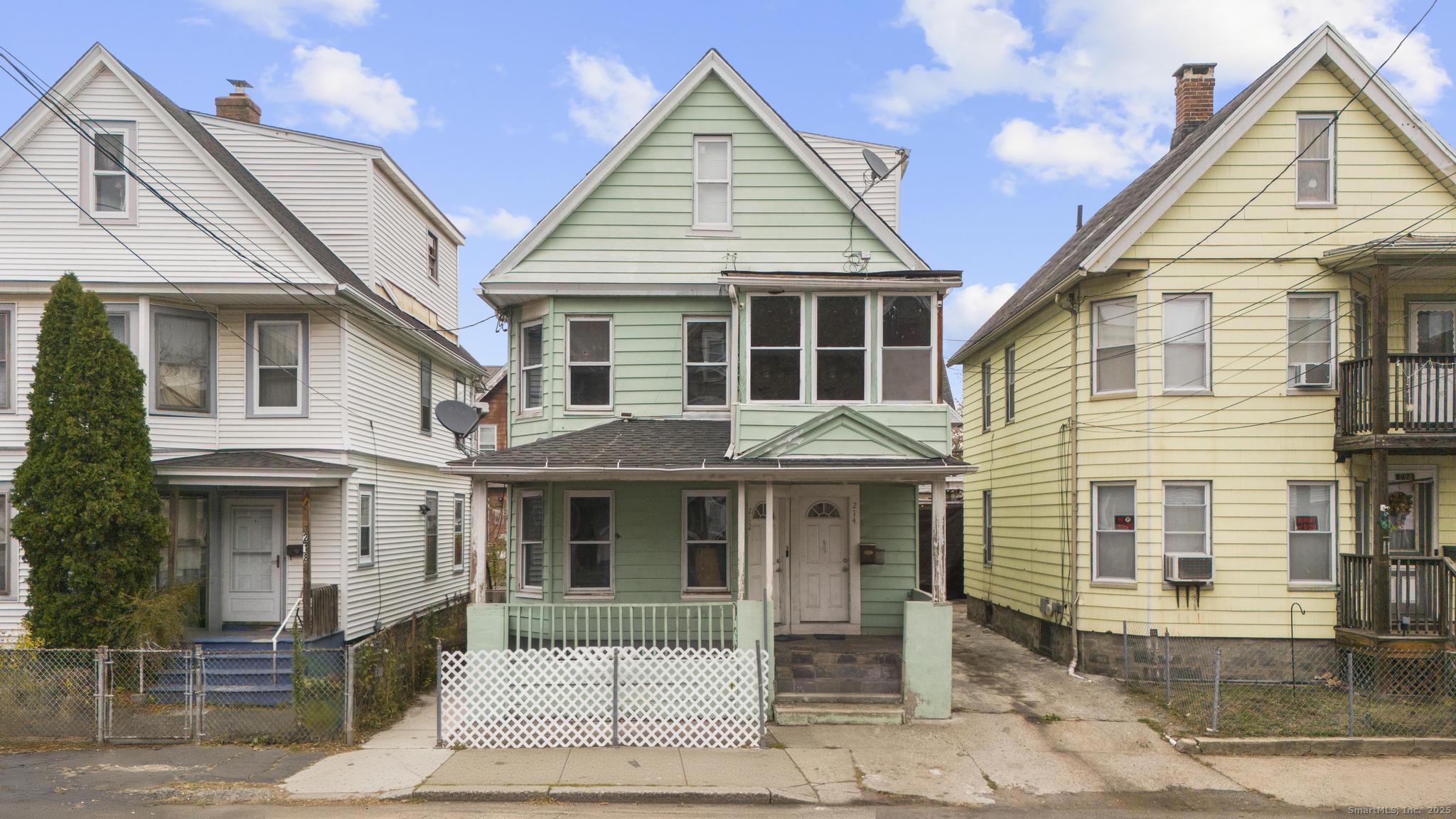 a view of a white house with large windows