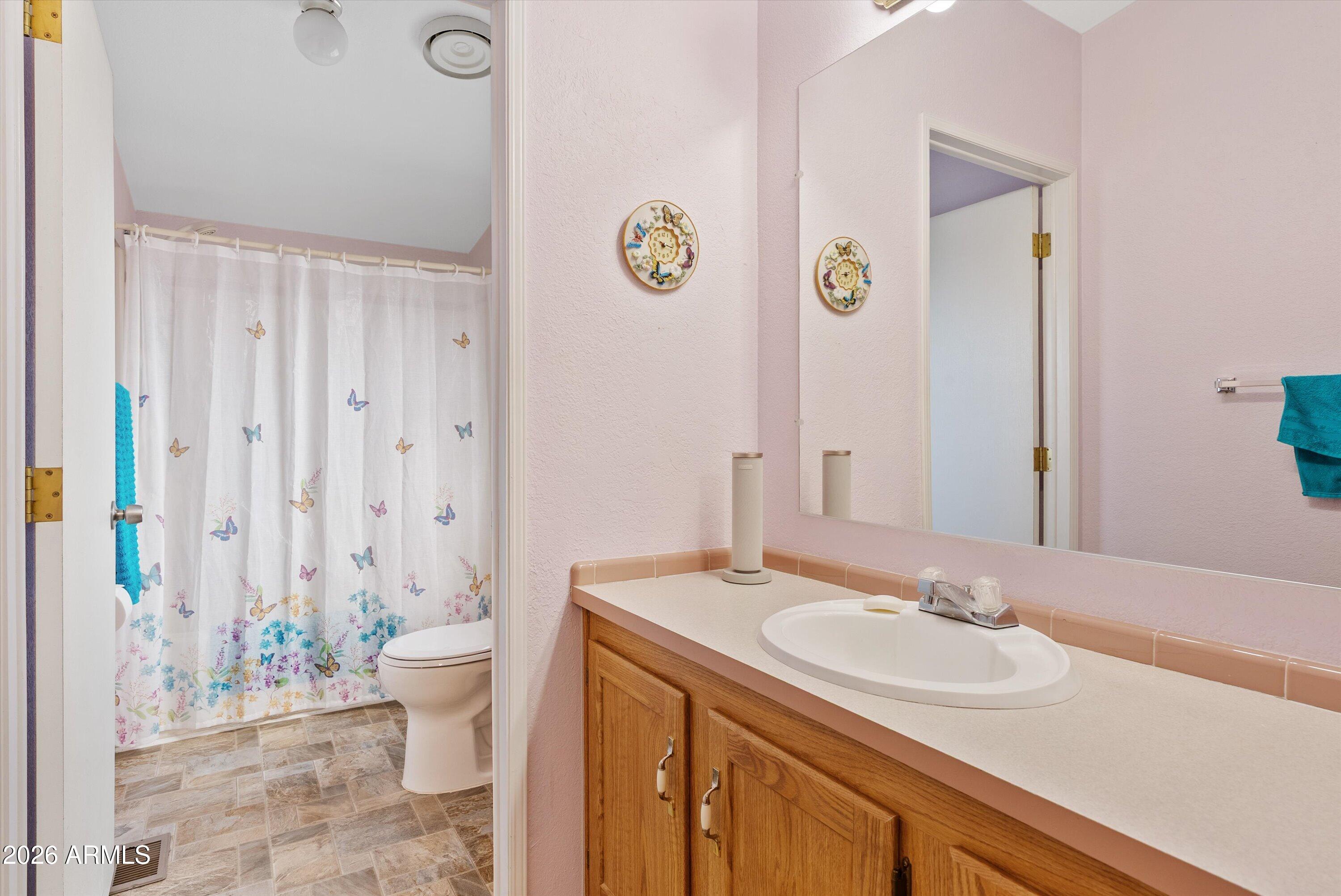 3700 South Tomahawk Road, Unit 91 Apache Junction, AZ 85119 - Photo 16 of 29 a bathroom with a sink and a mirror