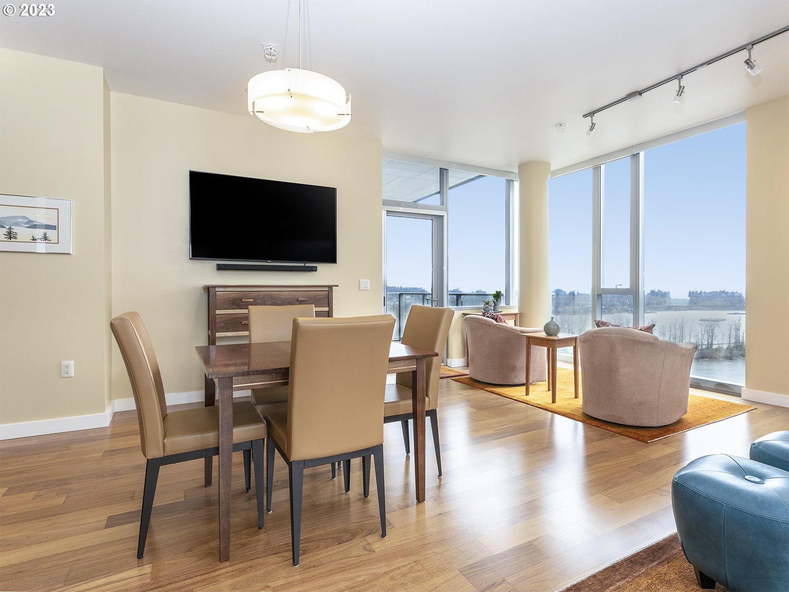 841 Southwest Gaines Street, Unit 1912 Portland, OR 97239 - Photo 11 of 32 a view of a dining room with furniture window and wooden floor