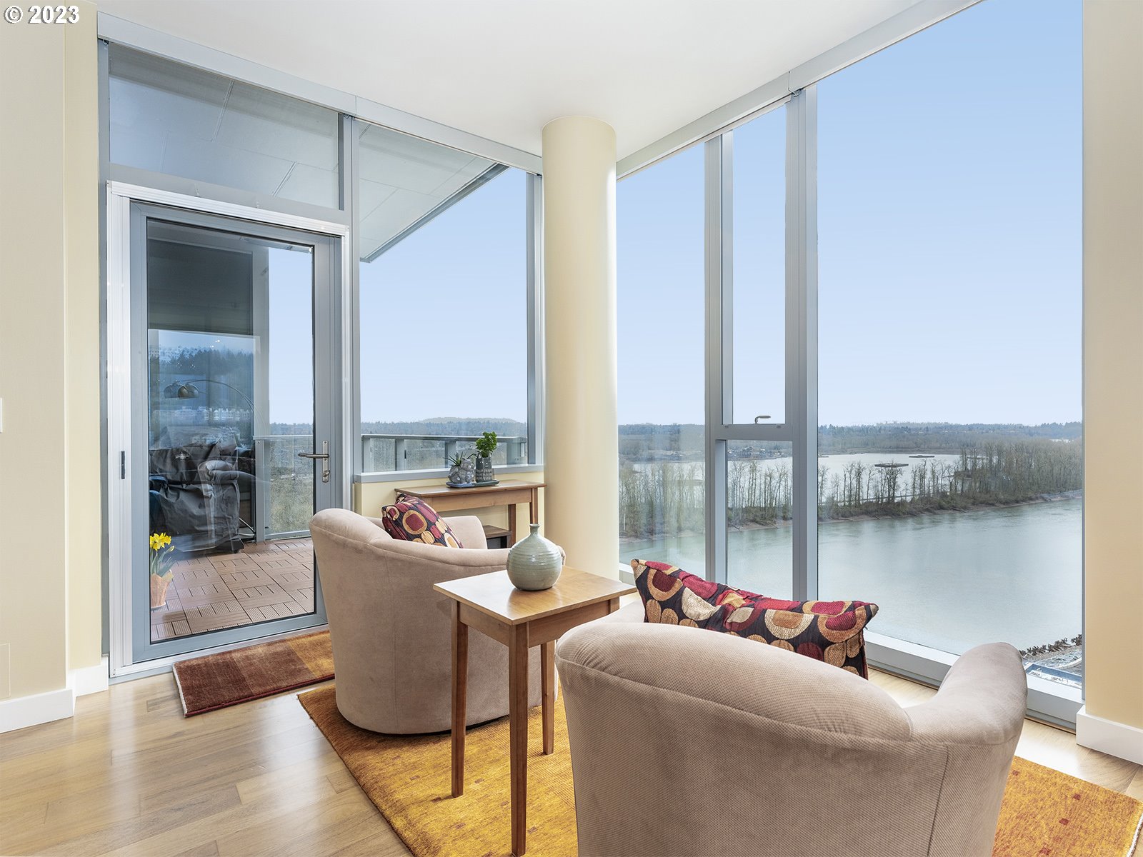 841 Southwest Gaines Street, Unit 1912 Portland, OR 97239 - Photo 15 of 32 a living room with furniture and a floor to ceiling window