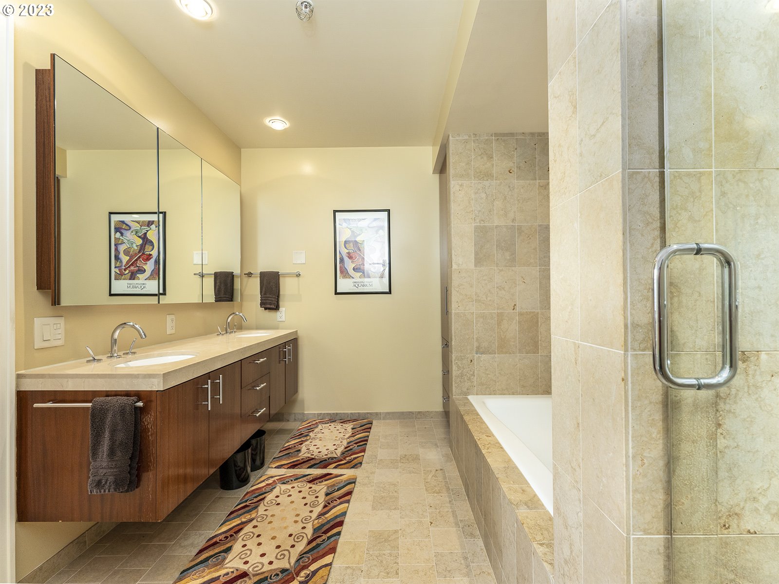 841 Southwest Gaines Street, Unit 1912 Portland, OR 97239 - Photo 23 of 32 a bathroom with a tub sink and mirror