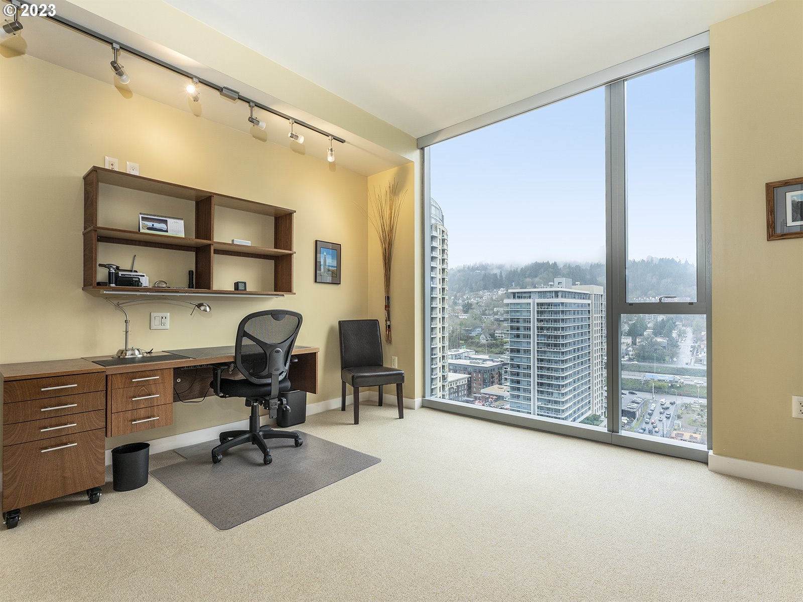 841 Southwest Gaines Street, Unit 1912 Portland, OR 97239 - Photo 26 of 32 a view of a workspace with furniture and a window