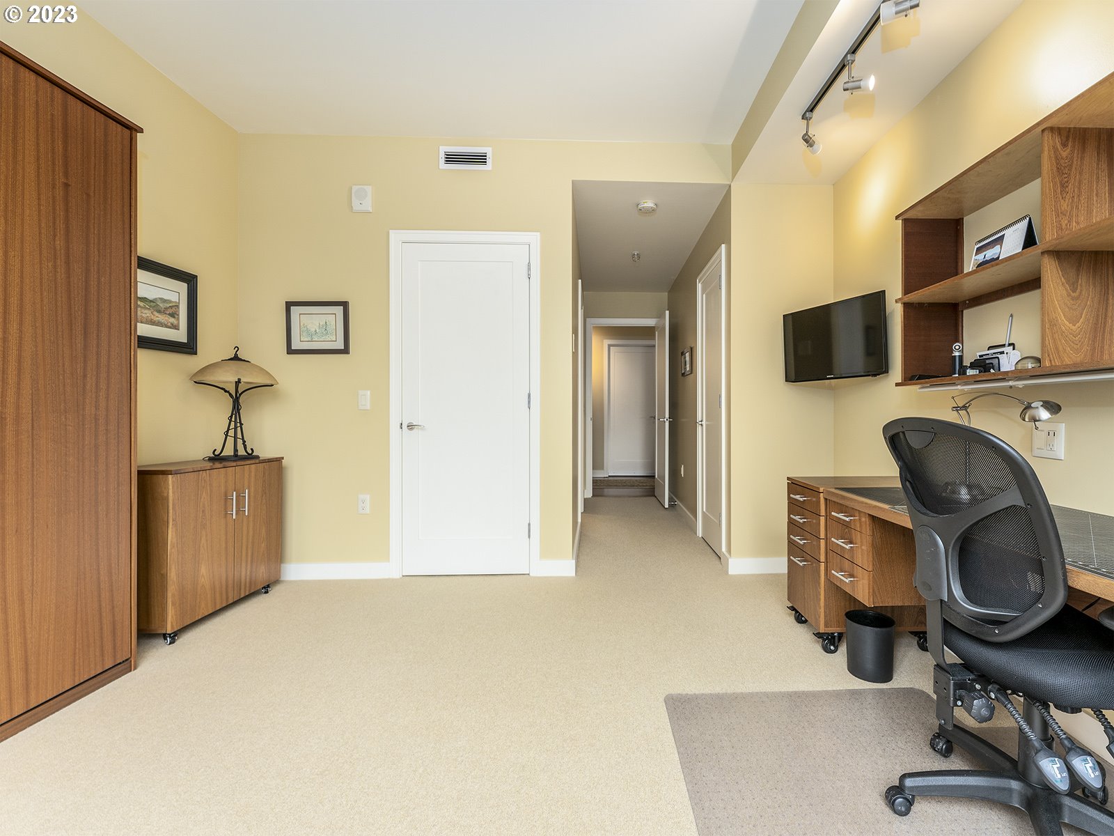 841 Southwest Gaines Street, Unit 1912 Portland, OR 97239 - Photo 27 of 32 a view of a workspace with furniture and a flat screen tv