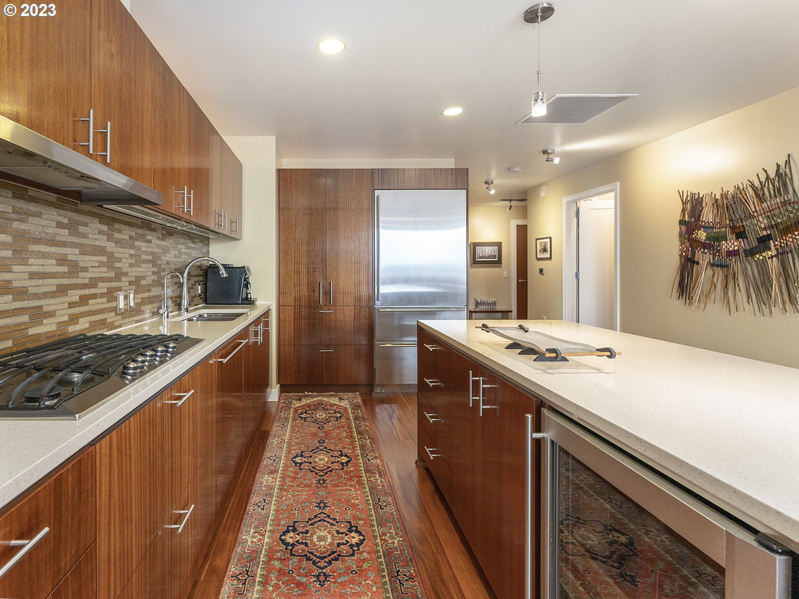 841 Southwest Gaines Street, Unit 1912 Portland, OR 97239 - Photo 7 of 32 a kitchen with stainless steel appliances granite countertop a sink and a stove