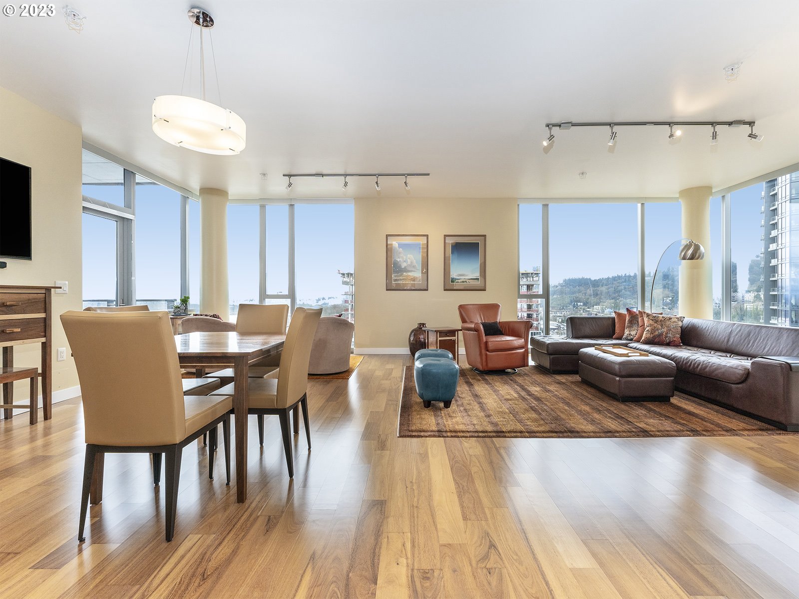 841 Southwest Gaines Street, Unit 1912 Portland, OR 97239 - Photo 10 of 32 a living room with furniture wooden floor and a chandelier
