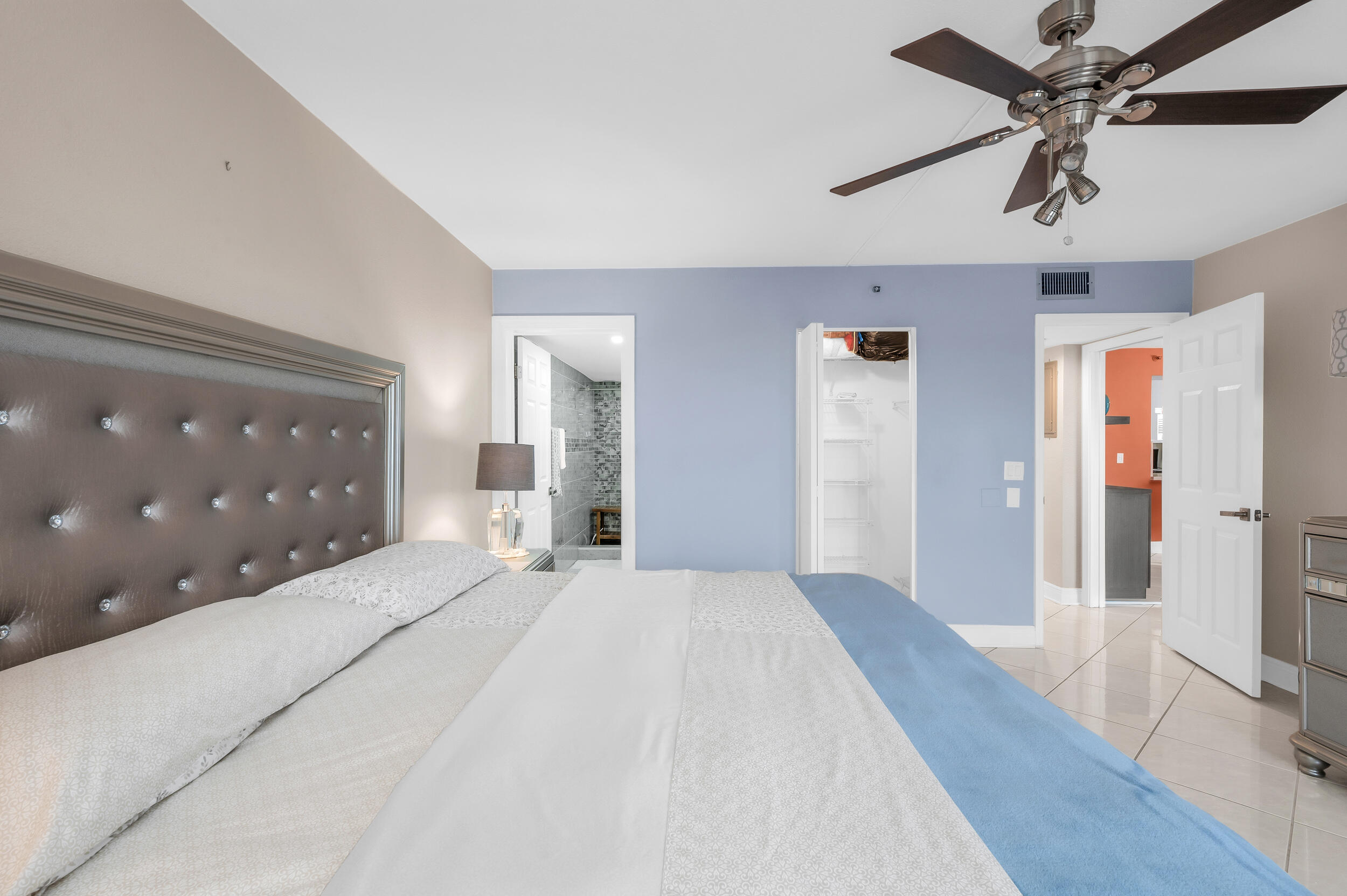 14475 Strathmore Lane, Unit 602 Delray Beach, FL 33446 - Photo 17 of 28 a large bedroom with a large bed and a chandelier