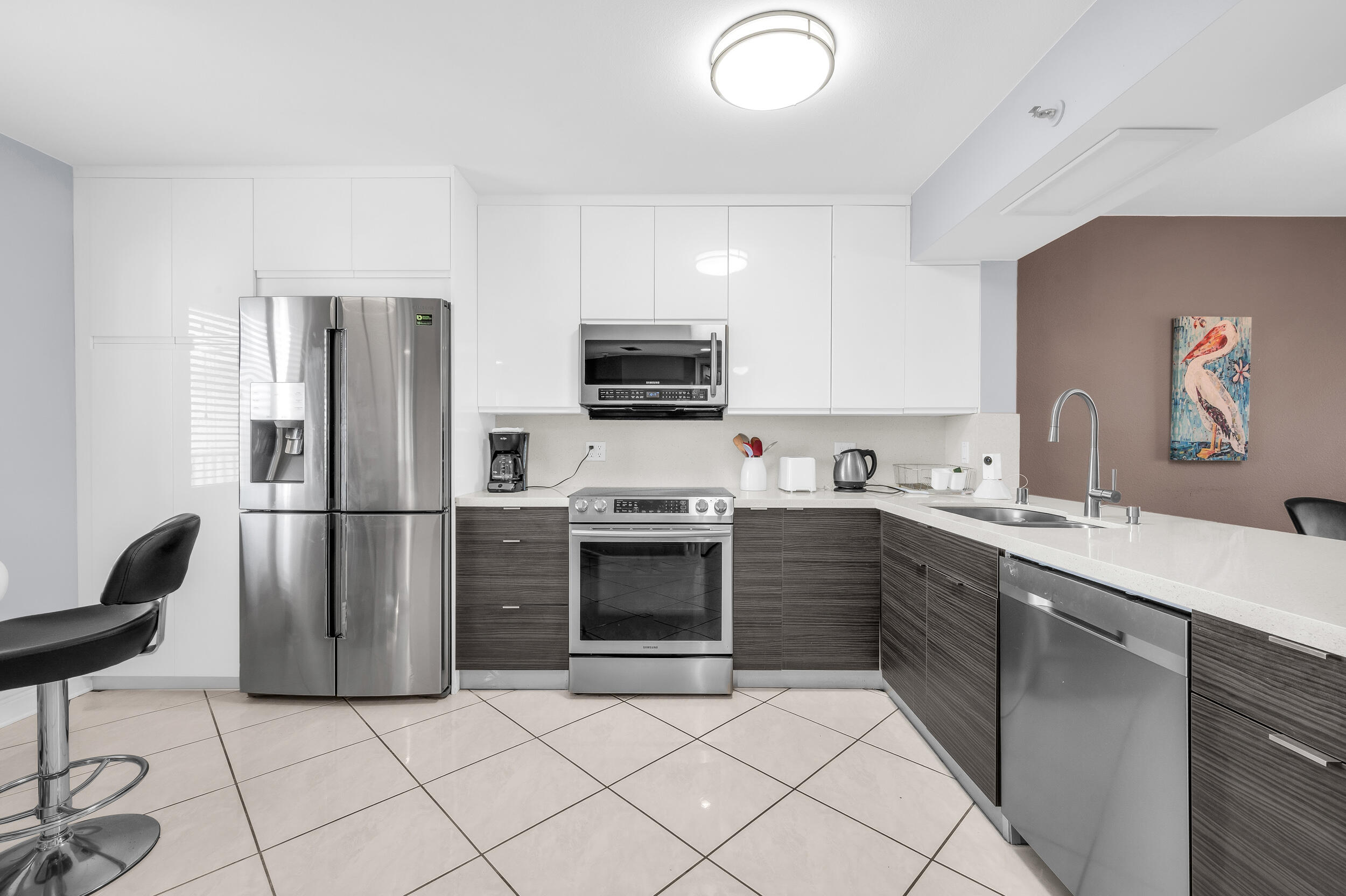 14475 Strathmore Lane, Unit 602 Delray Beach, FL 33446 - Photo 2 of 28 a kitchen with granite countertop a refrigerator stove and sink