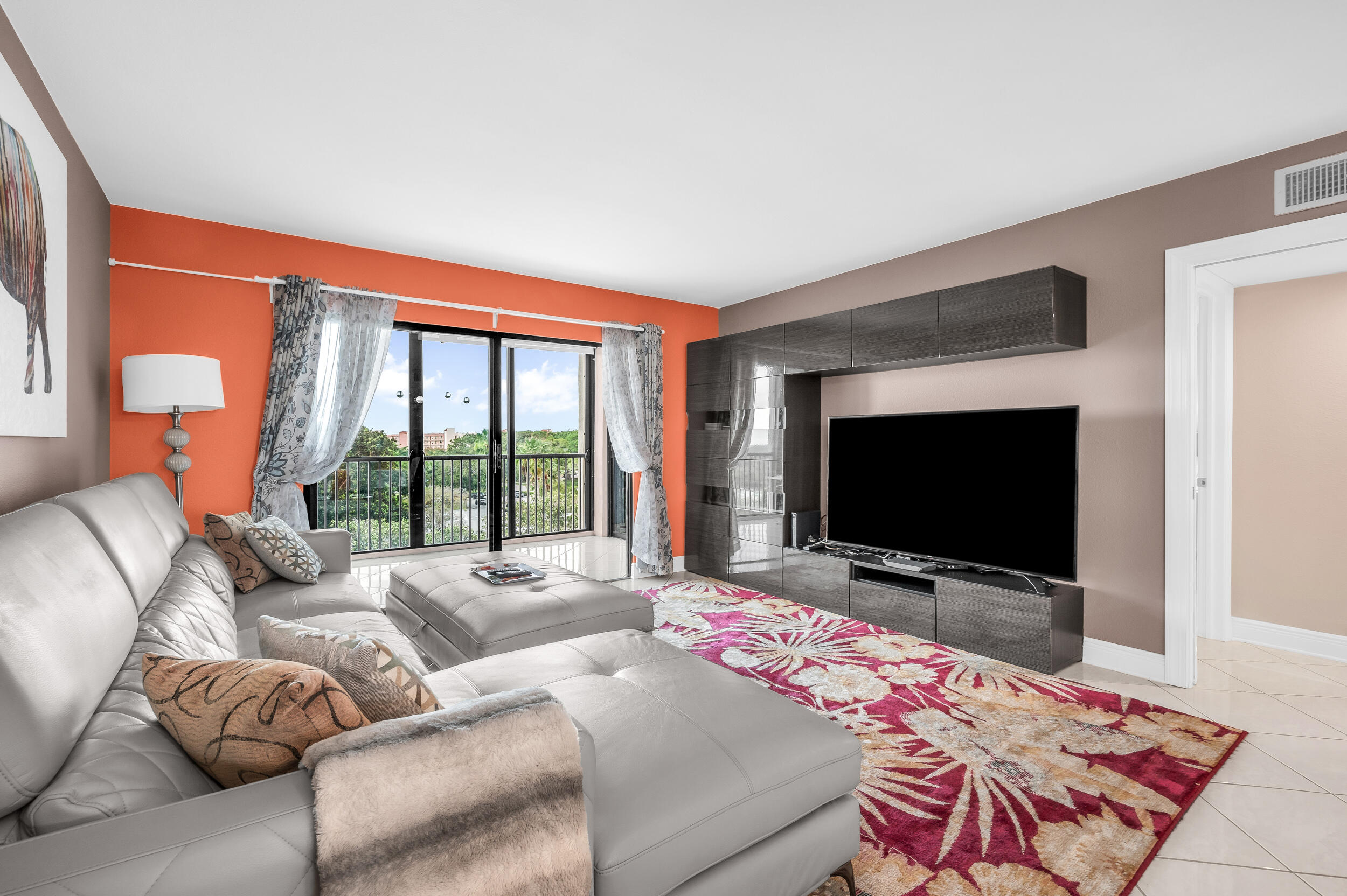 14475 Strathmore Lane, Unit 602 Delray Beach, FL 33446 - Photo 10 of 28 a living room with furniture and a flat screen tv