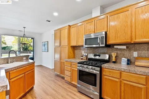 a kitchen with stainless steel appliances a stove sink and microwave