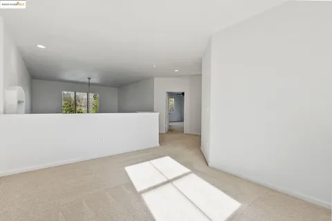 a view of a big room with wooden floor and windows