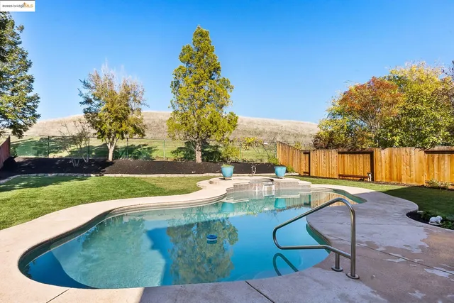 a view of a backyard with swimming pool