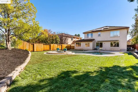a front view of a house with swimming pool yard and patio