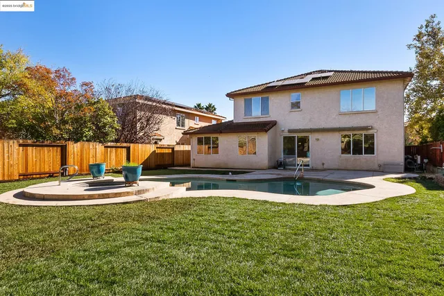 a front view of a house with a yard table and chairs