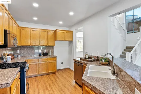 a kitchen that has a sink and a stove top oven