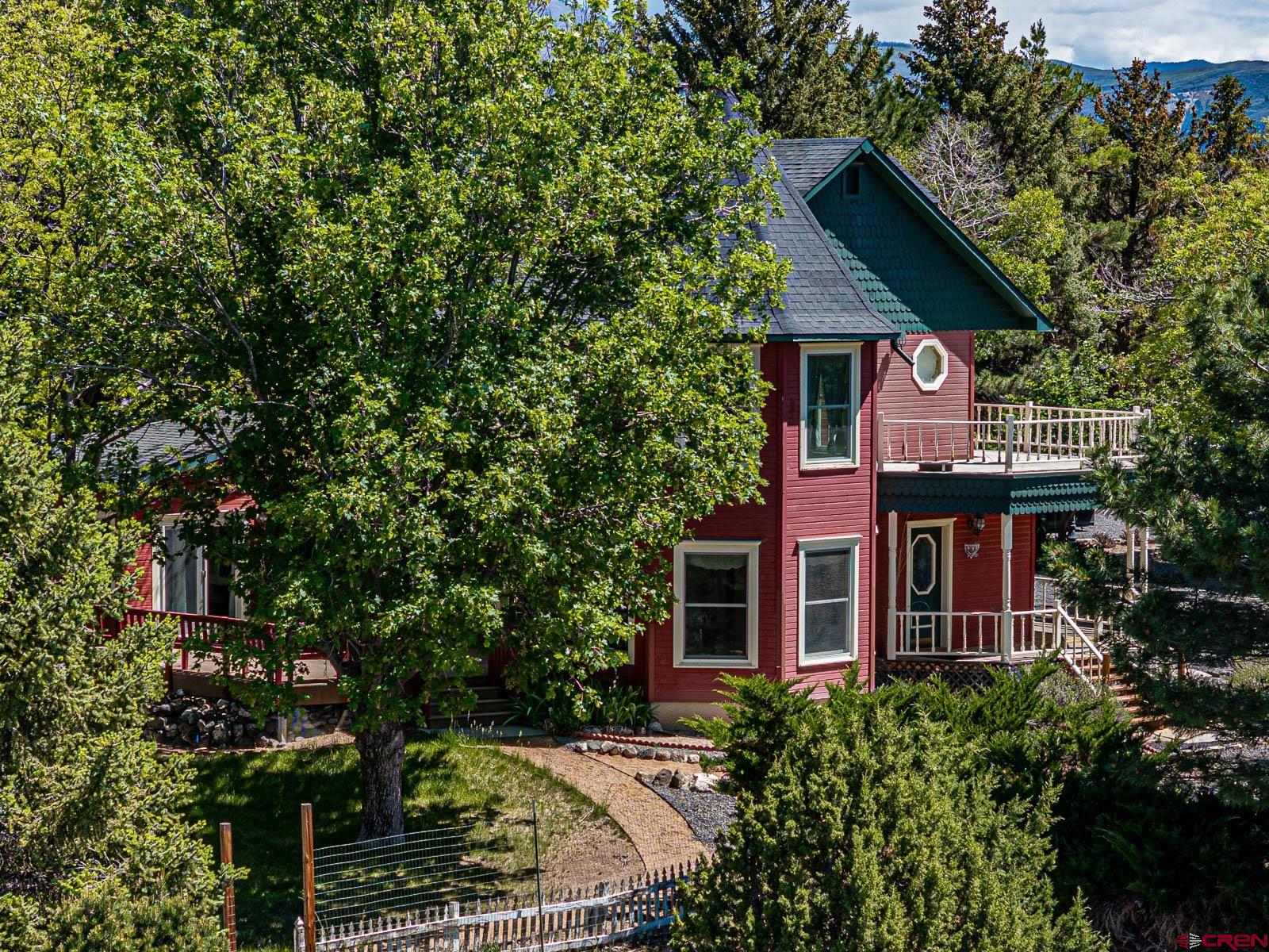 16331 2550th Road Cedaredge, CO 81413 - Photo 3 of 45 a front view of a house with garden