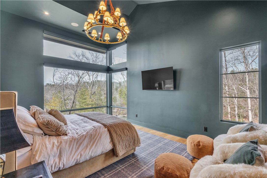 127 Crosswind Court Sunset, SC 29685 - Photo 15 of 49 This primary bedroom offers tranquil views, vaulted ceilings, and natural light.