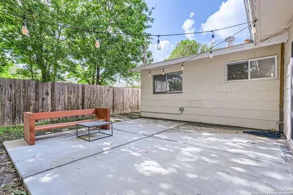 a backyard of a house with table and chairs