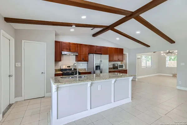 a kitchen with stainless steel appliances granite countertop a sink and cabinets