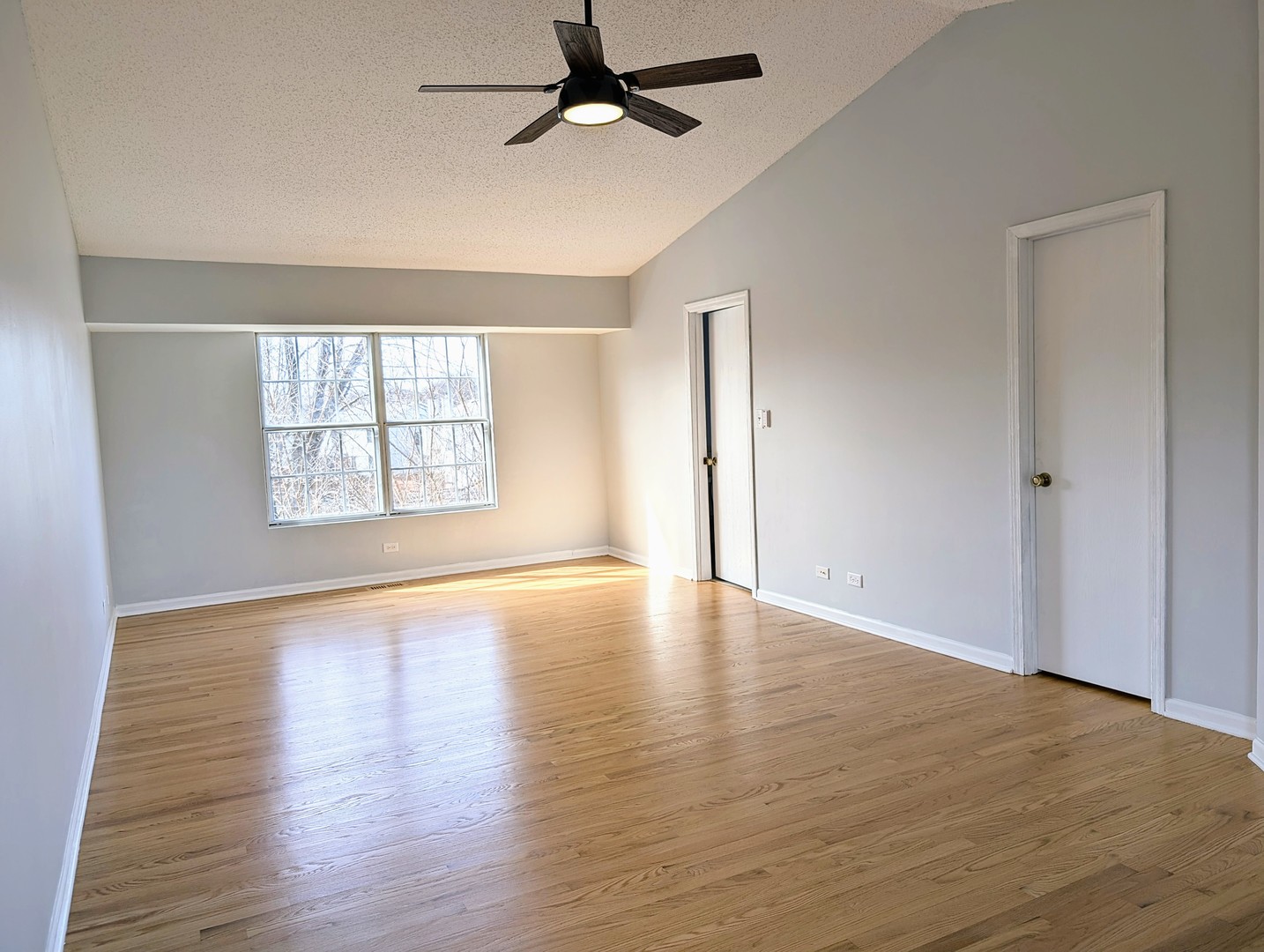 1030 Oak Ridge Drive Streamwood, IL 60107 - Photo 11 of 19 wooden floor in an empty room with a window