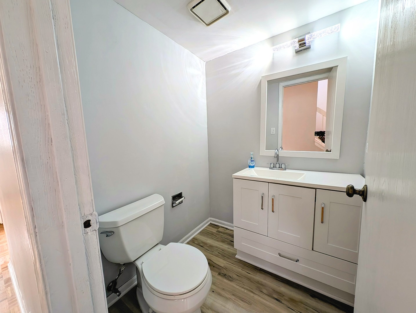 1030 Oak Ridge Drive Streamwood, IL 60107 - Photo 17 of 19 a bathroom with a toilet a sink a vanity and mirror