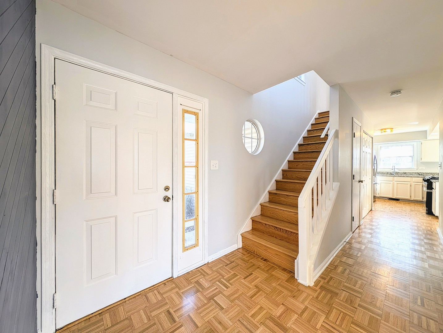 1030 Oak Ridge Drive Streamwood, IL 60107 - Photo 3 of 19 a view of a hallway with wooden floor and staircase