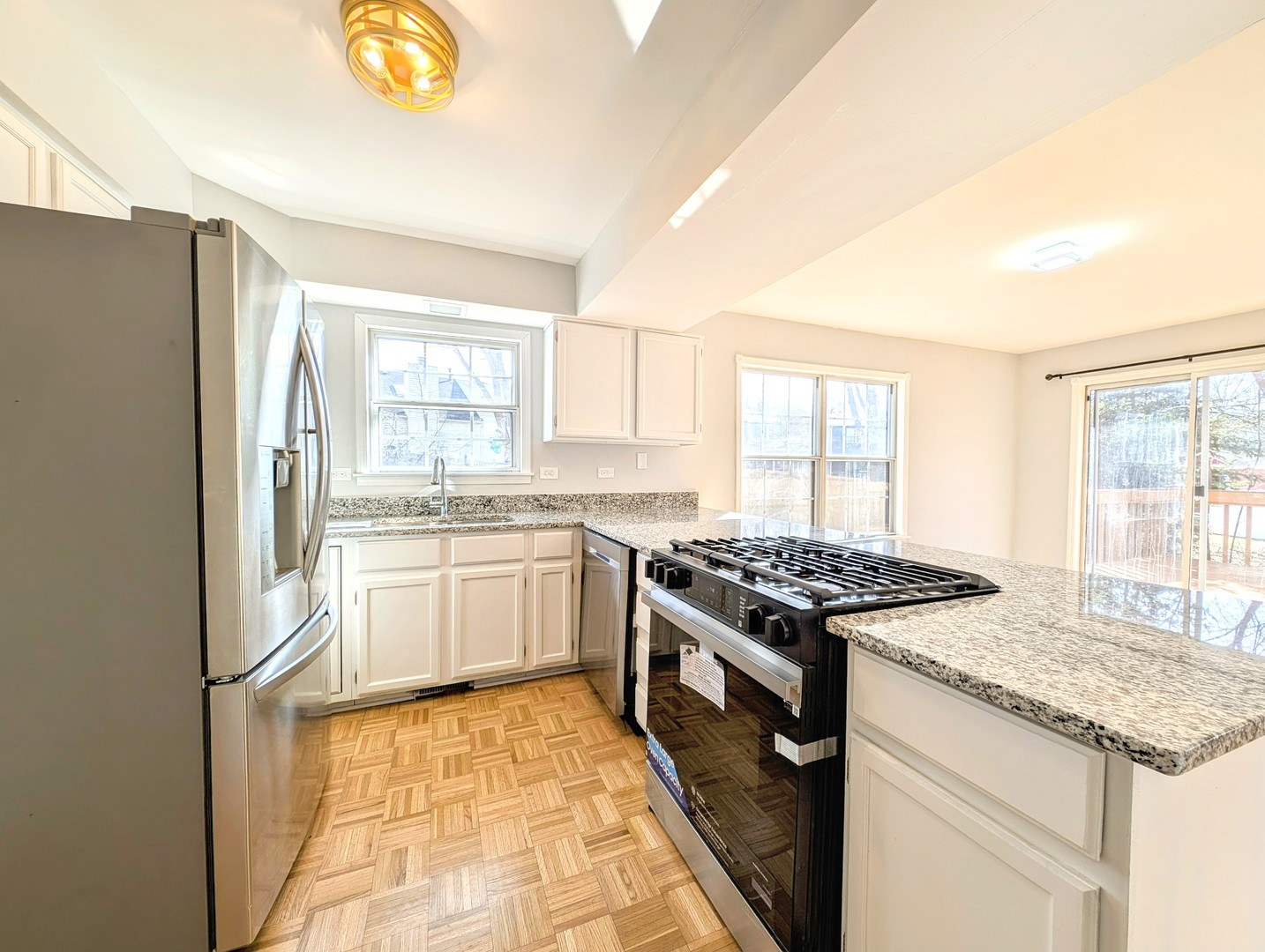 1030 Oak Ridge Drive Streamwood, IL 60107 - Photo 8 of 19 a kitchen with a stove a sink and a refrigerator