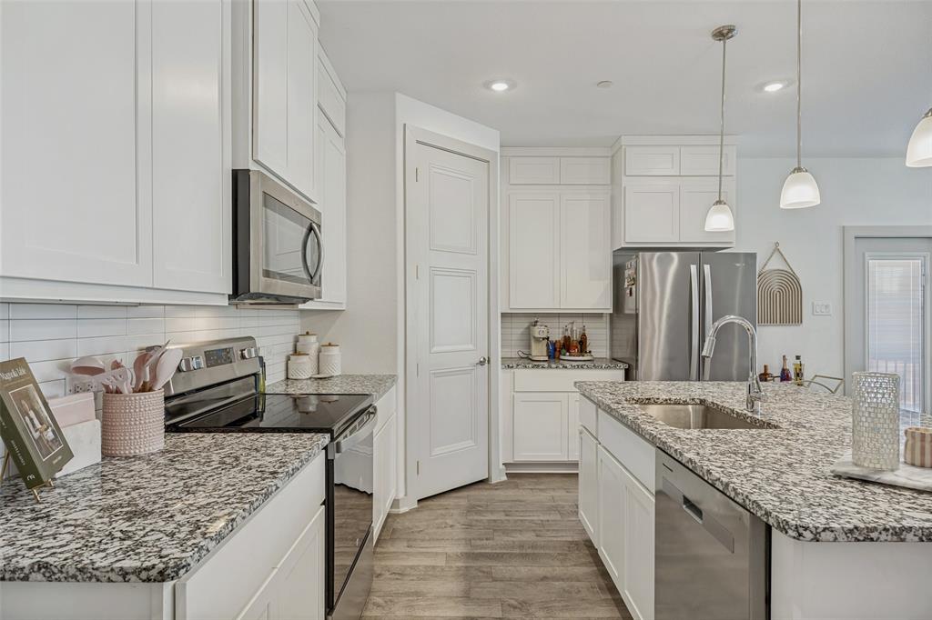 1650 Jessica Lane Allen, TX 75002 - Photo 9 of 25 a kitchen with stainless steel appliances granite countertop a sink a stove and a wooden cabinets