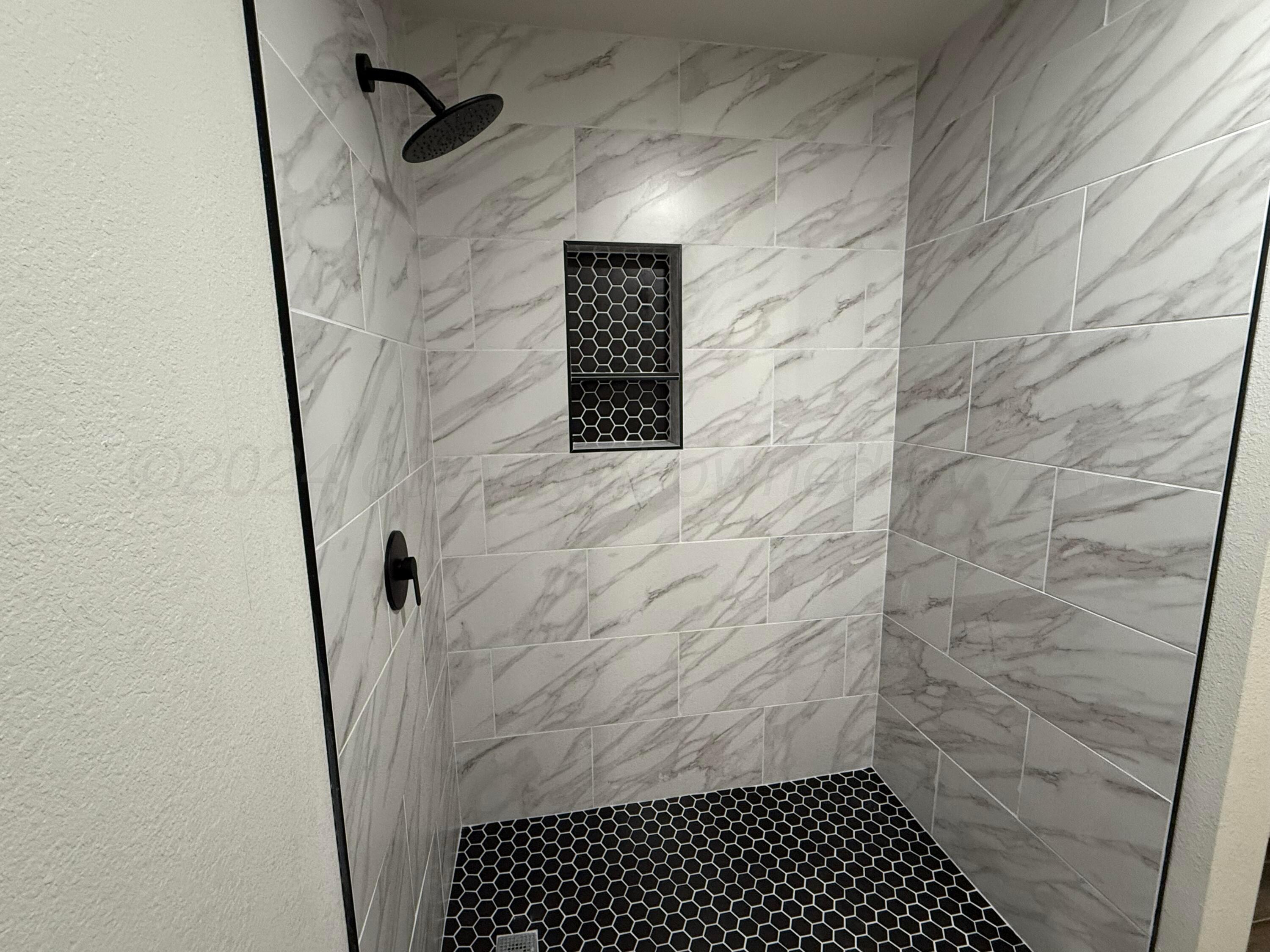 4914 Capulin Lane Amarillo, TX 79110 - Photo 11 of 25 a bathroom with a shower