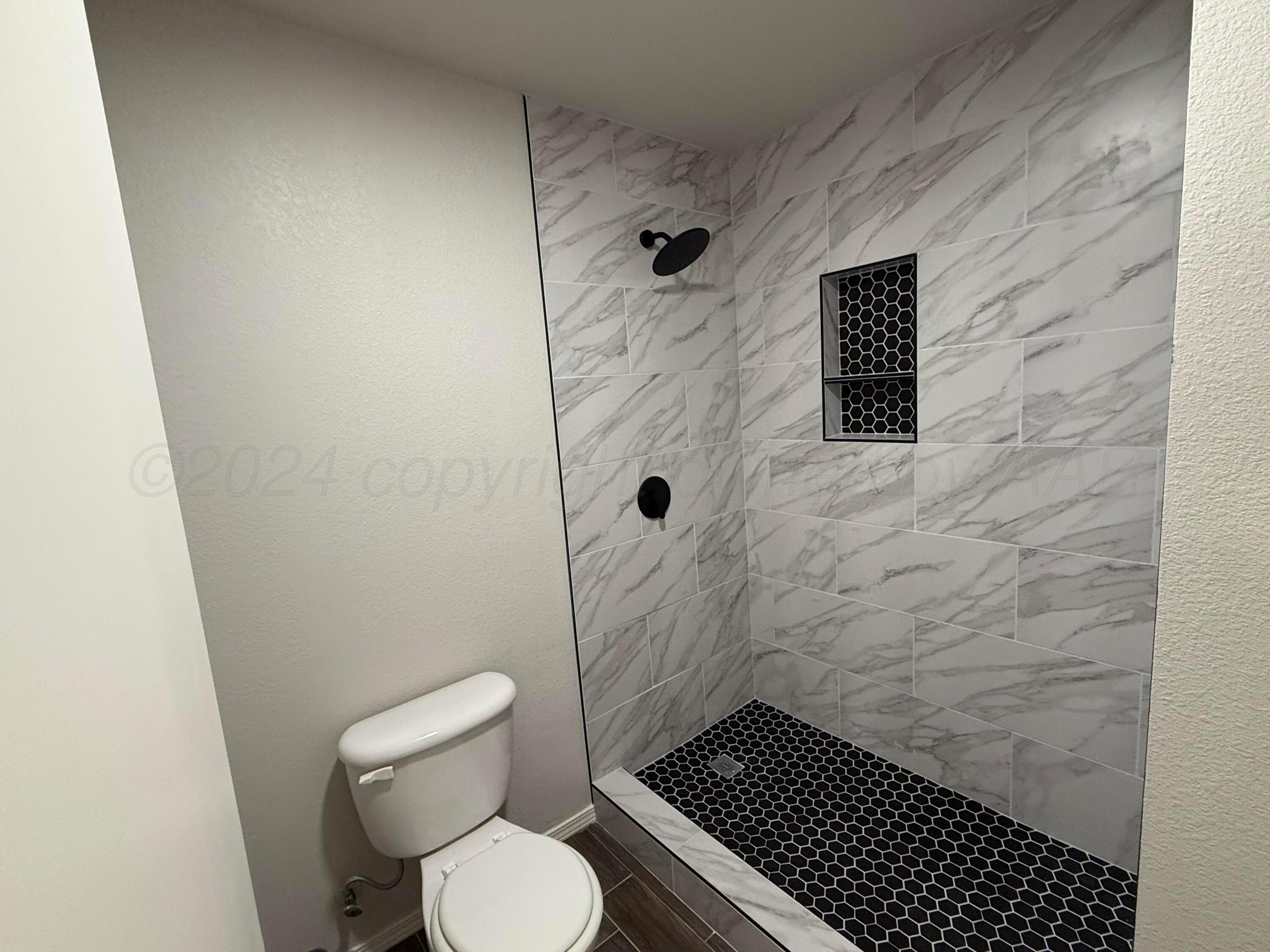 4914 Capulin Lane Amarillo, TX 79110 - Photo 15 of 25 a bathroom with a toilet