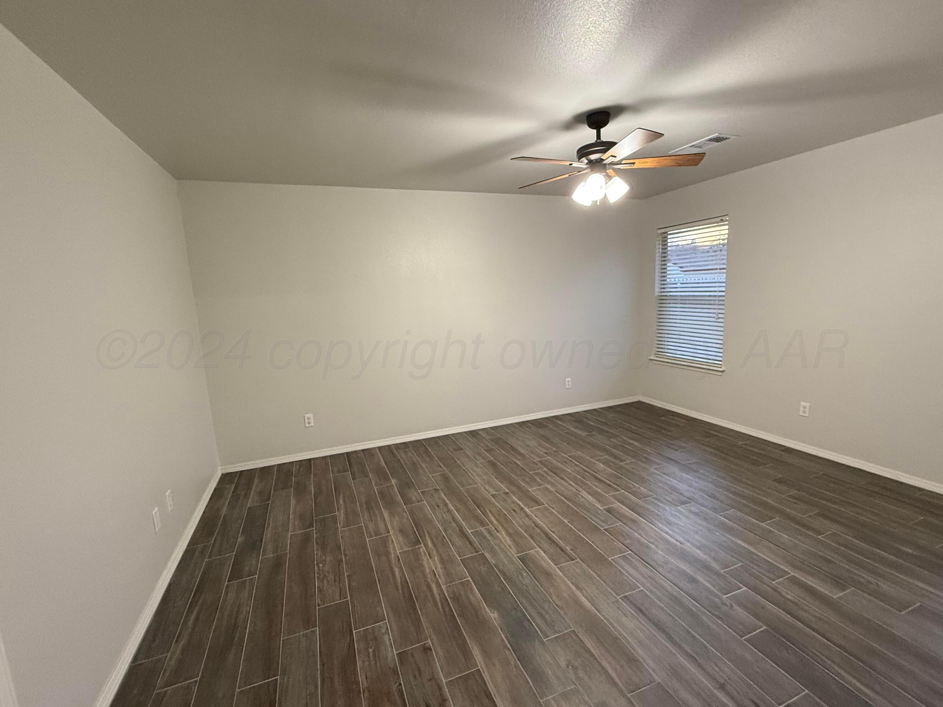 4914 Capulin Lane Amarillo, TX 79110 - Photo 10 of 25 a view of empty room with wooden floor