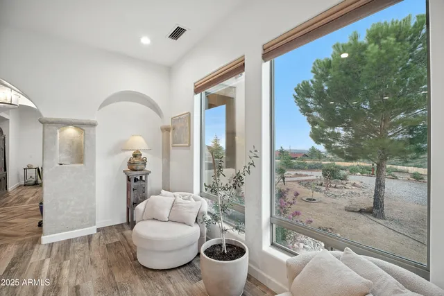 a bedroom with furniture and a large window